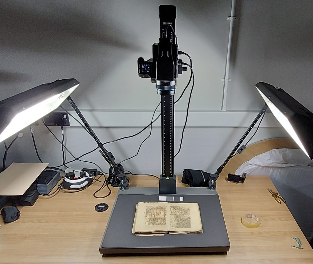 Camera stand with Arabic manuscript on top, ready for digitisation